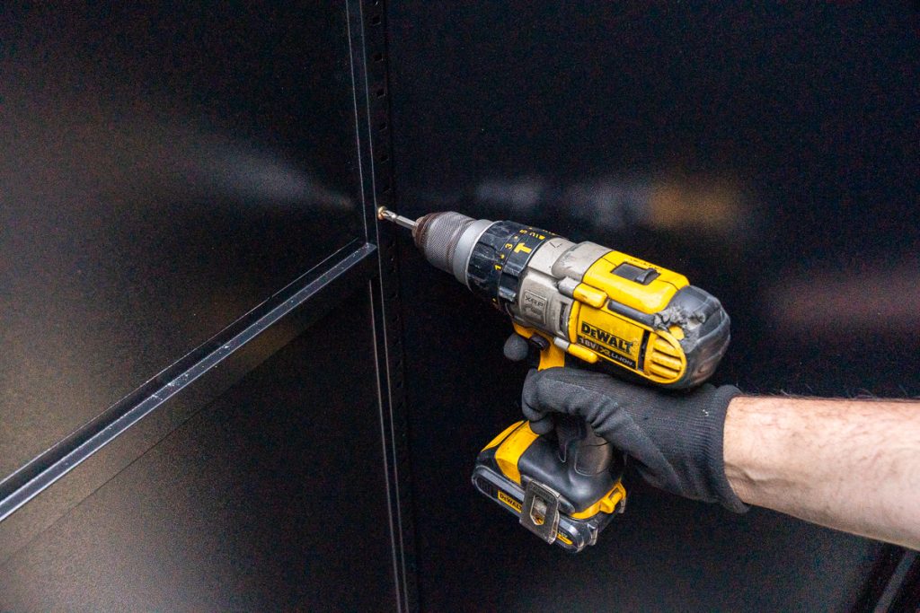 Building the Frame - Use a Phillips-head screwdriver to secure the back panel